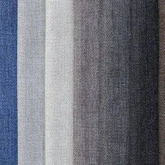 Muestras de tejido damasco en tonos azules, grises y marrones, con texturas visibles.