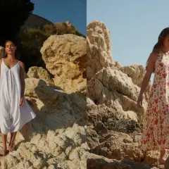 Mujer con vestido blanco de 100% viscosa y otro con estampado de coral, posando en rocas junto al mar.
