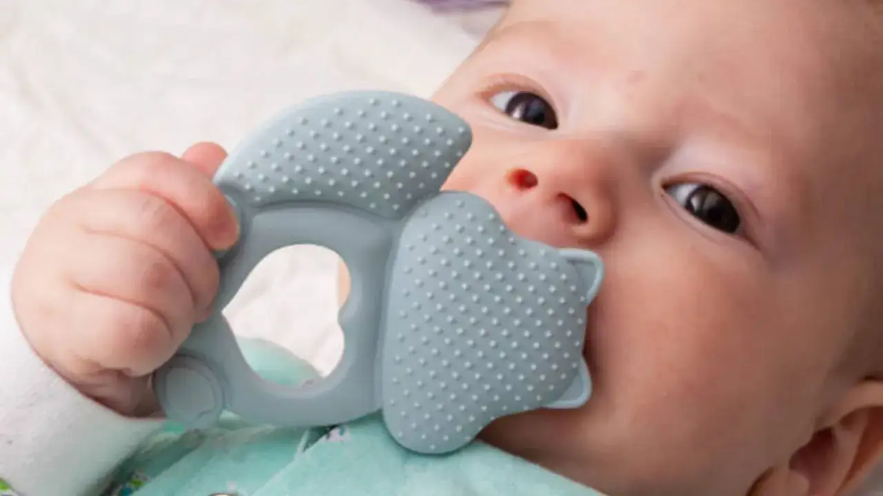 Beb&eacute; explorando su mordedor, ideal para aliviar las molestias de los dientes bebes.